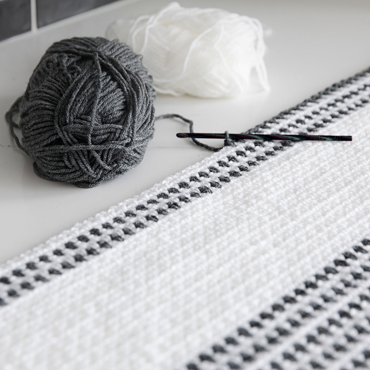 http://leelee-knits.myshopify.com/cdn/shop/products/Woven-Stitch-Crochet-Throw-02_1200x1200.jpg?v=1643385416
